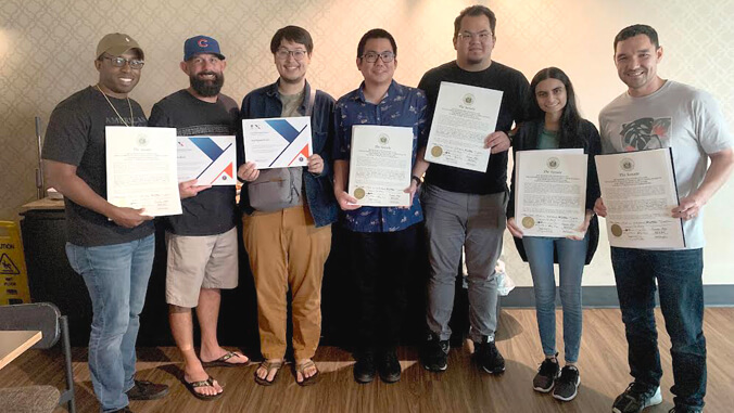 Group of students holding certificates