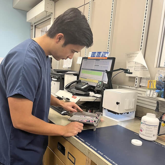 Pharmacy technician separating pills