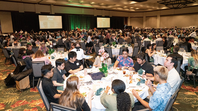 people sitting on tables in a banquet hall