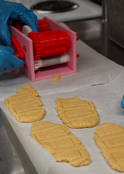 cookie cutter machine with freshly rolled and printed dough