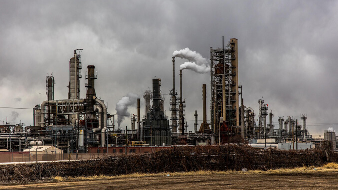 Industrial smokestacks against a cloudy gray sky