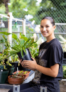 woman holding a plant