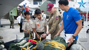 Boy scouts looking at military gear