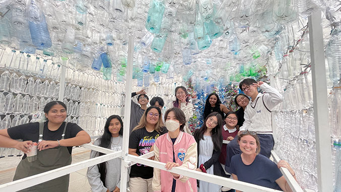 students under pavilion of bottles