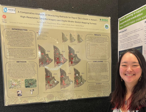 Student standing in front of her research poster