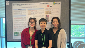 Group of people smiling in front of research poster