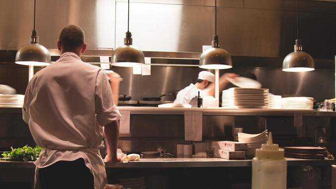 Two workers in a restaurant kitchen