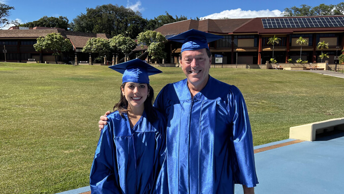 Daughter and father in Kapiolani C C graduation regalia