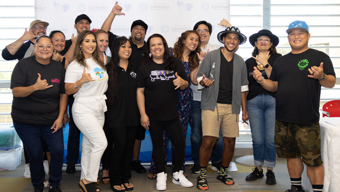 People smiling flashing shaka
