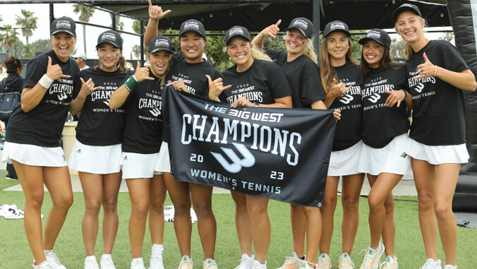 A group of people holding a banner