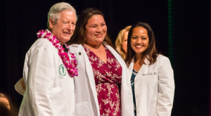 three people wearing white coats