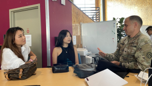 three people talking at a table