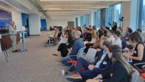 person speaking to a crowd of people