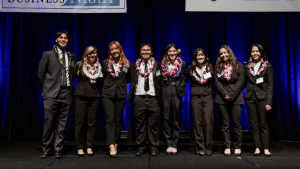 people with lei standing on a stage