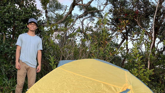 student smiling by tent