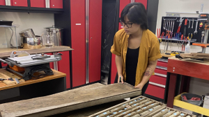 student holding wood