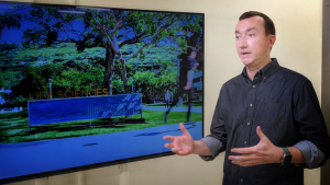 man talking by television
