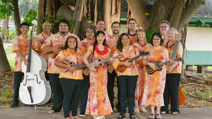 Group of people smiling, holding instruments