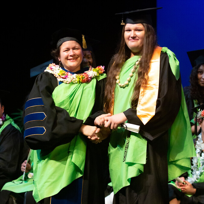 Mother presenting daughter with college diploma