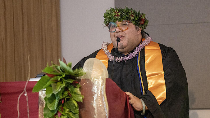 kawena lorenzo speaking at podium