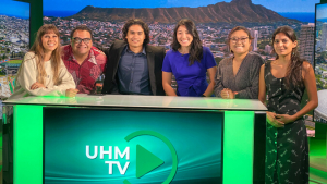 several people standing in front of a desk