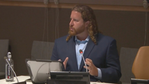 person speaking at a desk