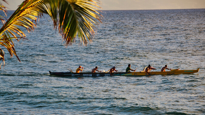 Men paddling an outrigger canoe