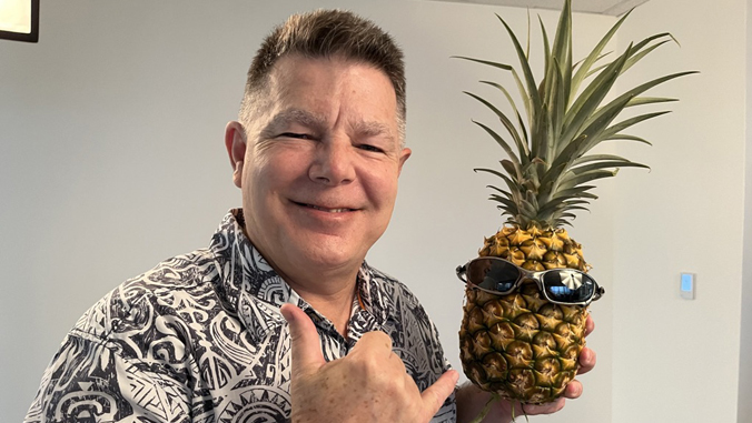 person smiling with a pineapple
