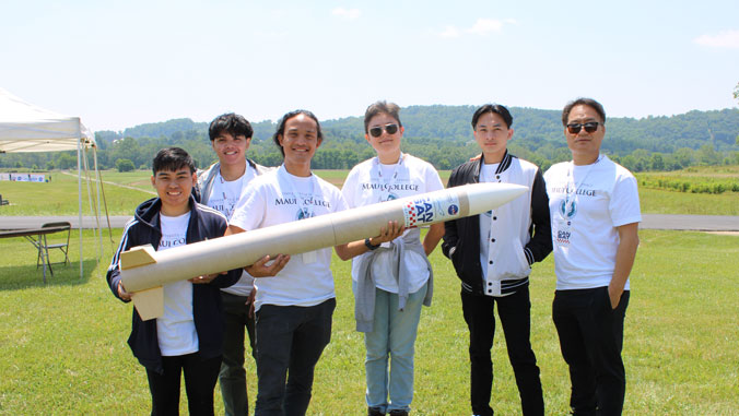 people standing and holding rocket