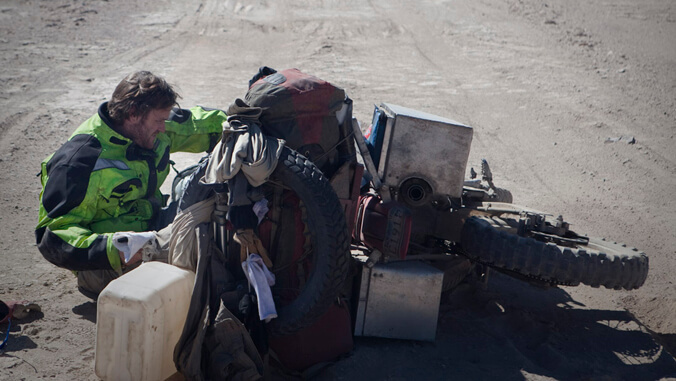 person working on his motorcycle