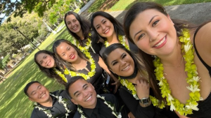 group of students smiling and wearing lei