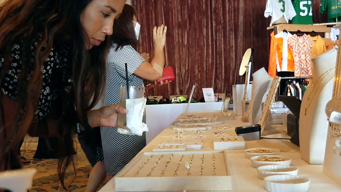 person looking at items on a table