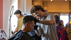 person cutting another person's hair