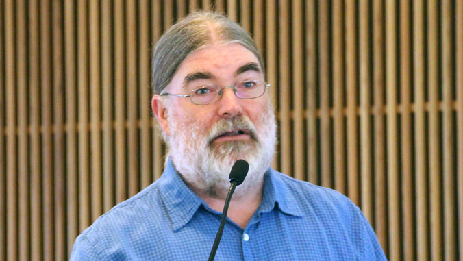 man standing behind podium