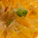 A cut open tangerine with a sprouting seed