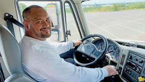 Someone holding a steering wheel in a vehicle