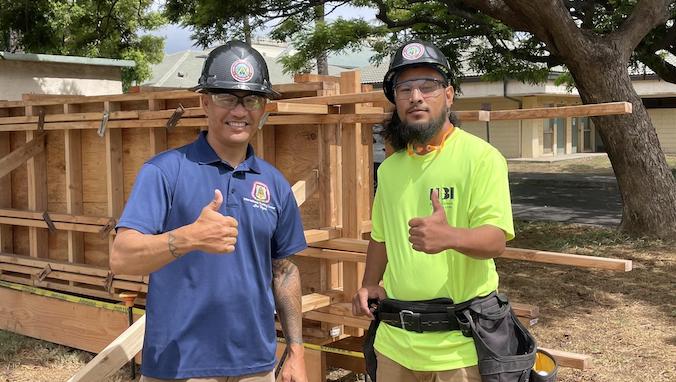 carpentry student and instructor giving the shaka