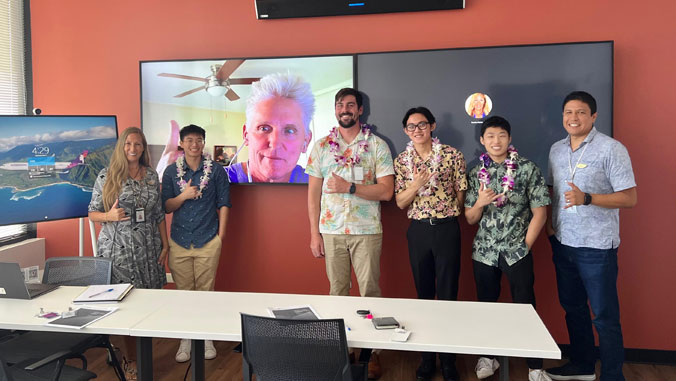 6 people standing in conference room