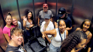 people in an elevator with bags