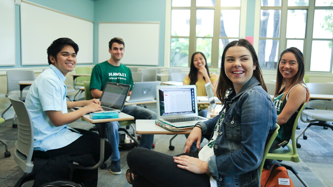 five people sitting in a classroom