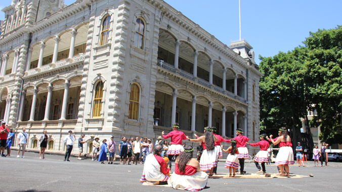 People performing hula outside Iolani Palace