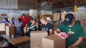 students preparing food boxes