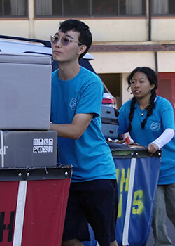 student volunteers helping move items