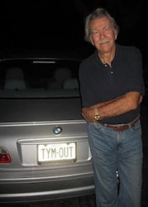 Staats standing next to car showing time out license plate