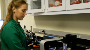 person in a green lab coat