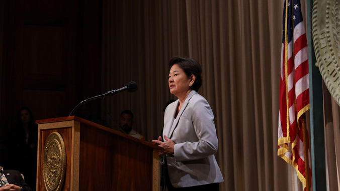 woman at speaker podium