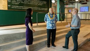 three people standing in a building