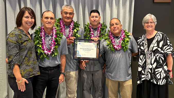 group of people holding a certificate