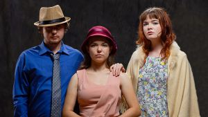 Three actors in their costumes.