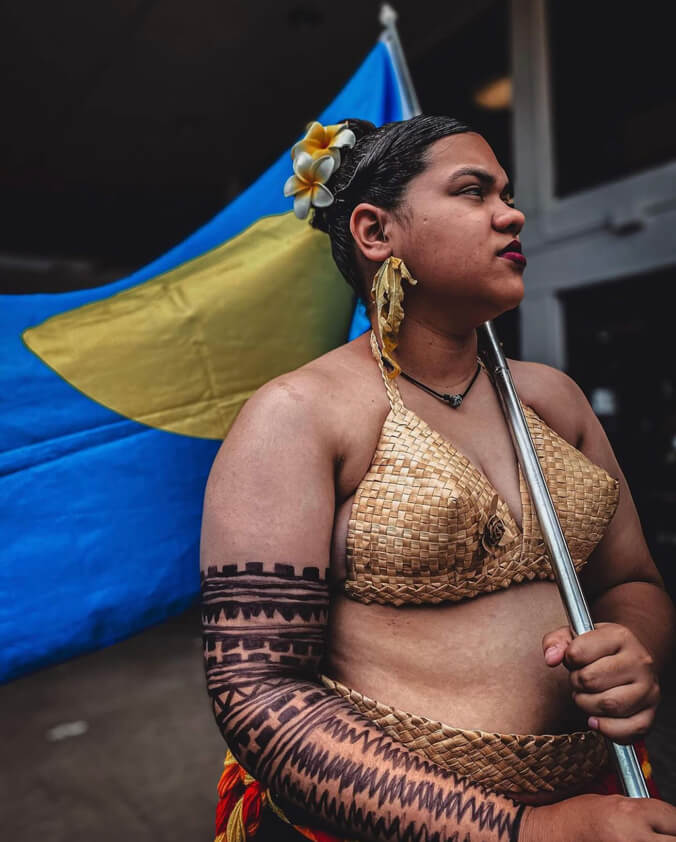 Woman holding the flag of Palau